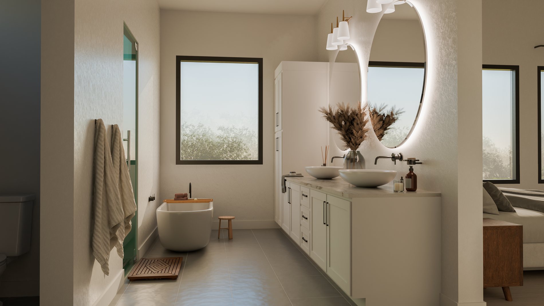 Long primary bath with vessel sinks, backlit round mirrors and freestanding tub